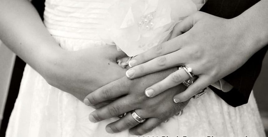 black and white close up wedding picture of the bride and groom's hands